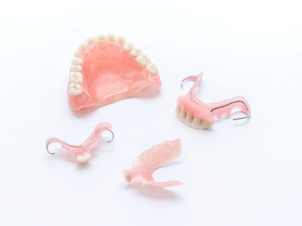 different denture types laid out on a white background