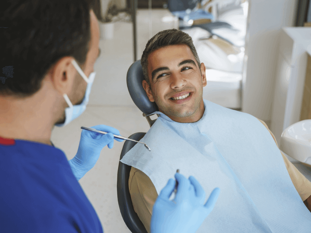 patient in operating chair smiling at doctor