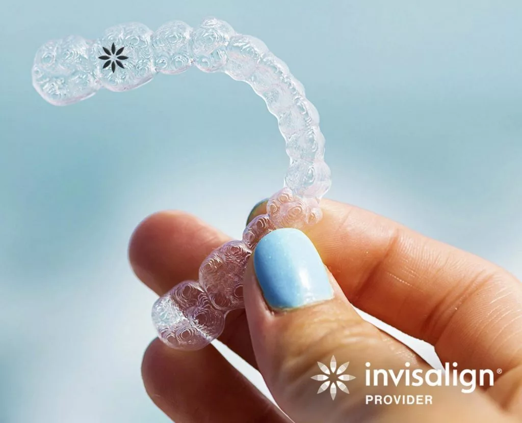 hand holding an invisalign retainer