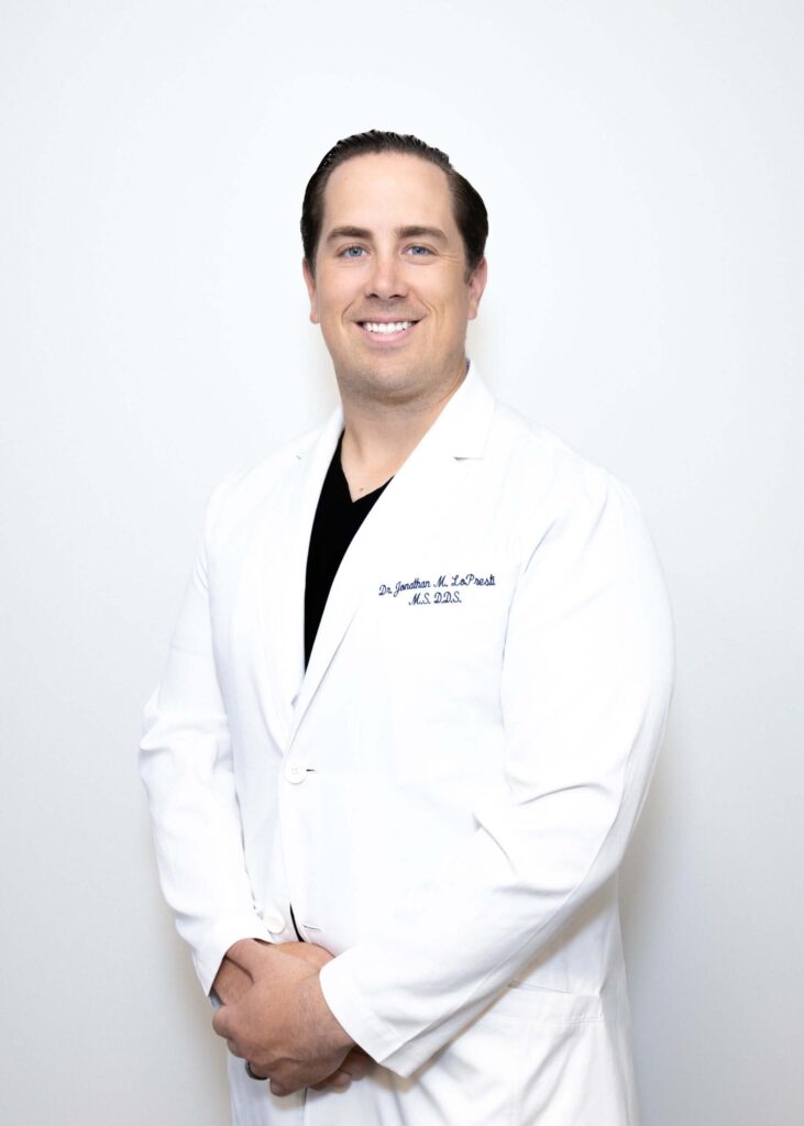 dr. lopresti headshot with white dentist gown