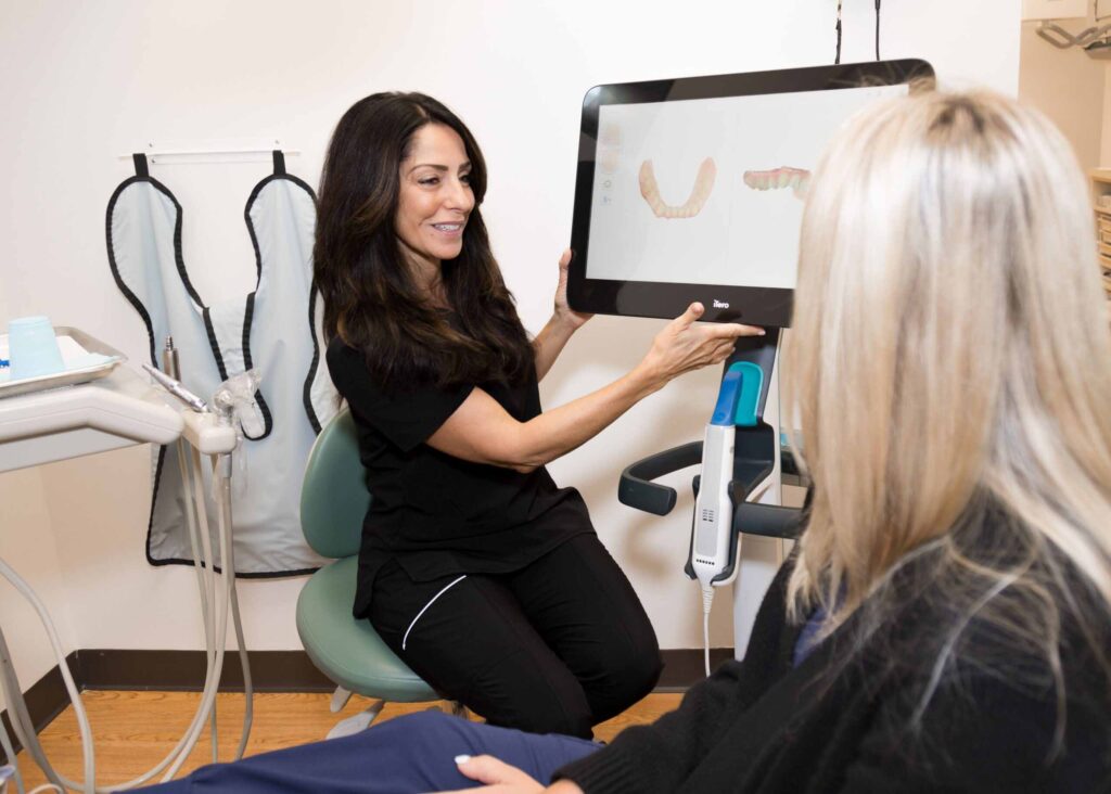 Rosemarie showing a patient an intraoral scan